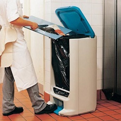 A chef using a Hippo Catering Waste Bin in a commercial kitchen