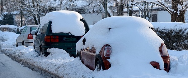 Tre bilar med snö
